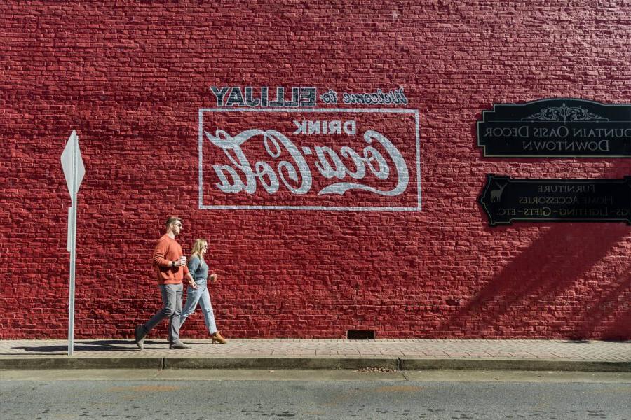 A brick wall with Welcome to Ellijay and the Coca Cola logo